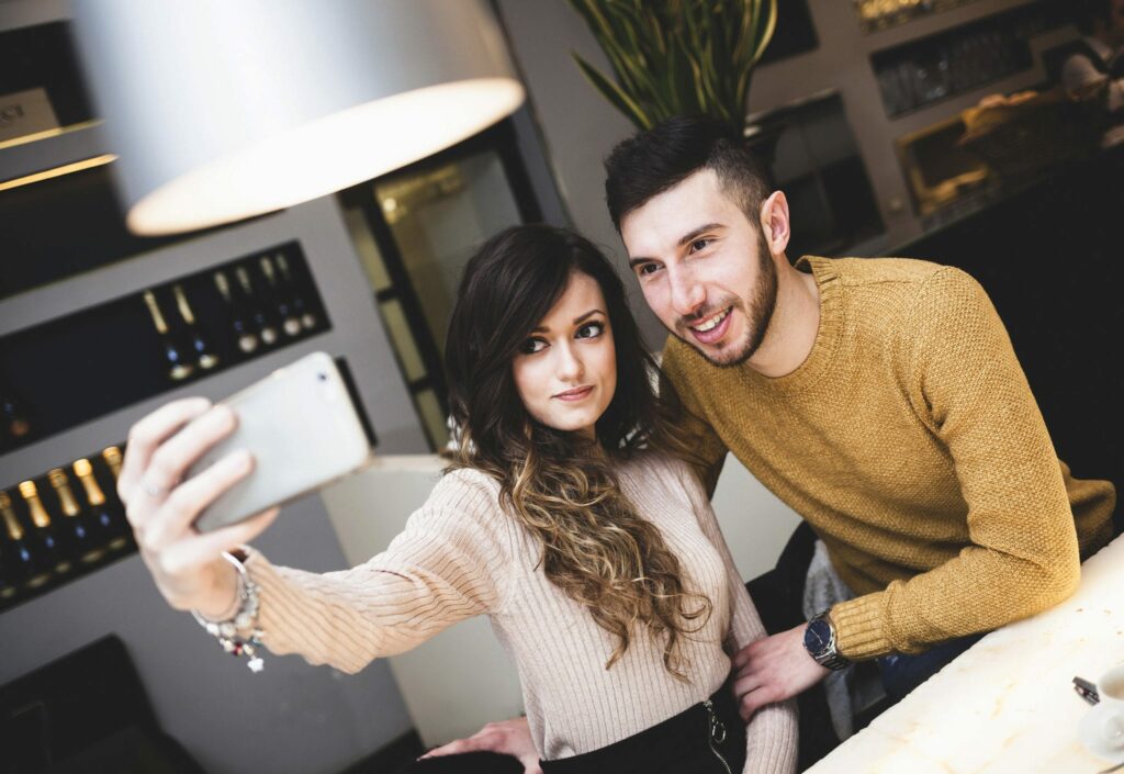 Young couple at the bar taking a selfie