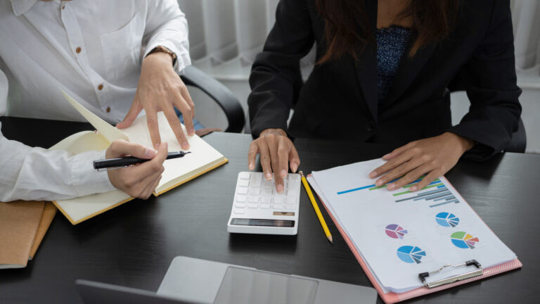 Cropped shot of business partners calculate financial data and d